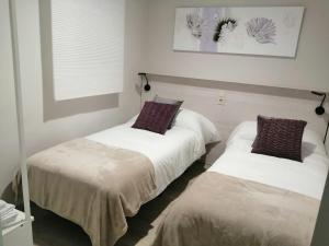a room with two beds and a window at CALDERON in La Roda