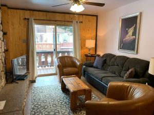 a living room with a couch and a table at Telemark #4 Townhouse On The River in Red River