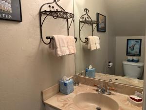 a bathroom with a sink and a mirror at Telemark #4 Townhouse On The River in Red River +16 photos