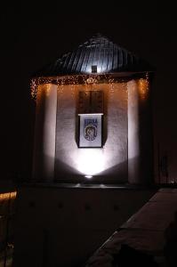 a building with a sign on it with lights at Komfortita in Utena