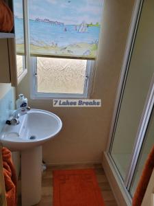 a bathroom with a sink and a window at 7 Lakes Breaks at 7 Lakes Country Park in Crowle