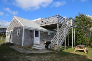 a small house with a ladder on the side of it at 75 Freeman Avenue Sandwich - Cape Cod in Sandwich