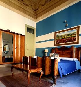 a bedroom with a bed and a table in a room at Cavour Il Conte Camillo in Palermo +15 photos