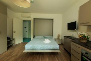 a bedroom with a bed and a flat screen tv at Residence San Francesco in Tirrenia