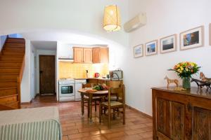 a kitchen with a table and a dining room at Les Gites du Merle in Cogolin