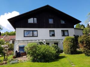 een huis met een zwart-wit dak bij Harzhaus Rauch in Braunlage