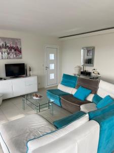a living room with a couch and a tv at Le Loft in Ajaccio
