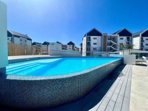 a swimming pool in the middle of a building at The Penguin Cove in Summerstrand