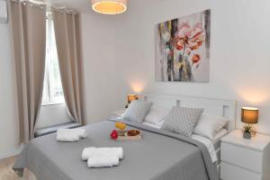 a bedroom with a bed with two towels on it at Apartman Leona in Lovran