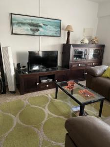 a living room with a flat screen tv and a coffee table at Vivienda vacacional Josver in Benicàssim