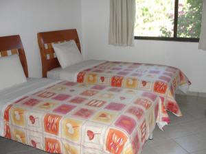 מיטה או מיטות בחדר ב-Las Casitas Tepoztlán