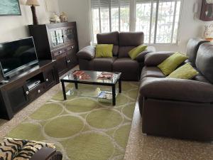 a living room with a couch and a coffee table at Vivienda vacacional Josver in Benicàssim