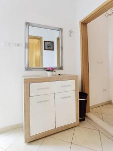 a bathroom with a sink and a mirror at Apartment Rina - Old Town in Dubrovnik