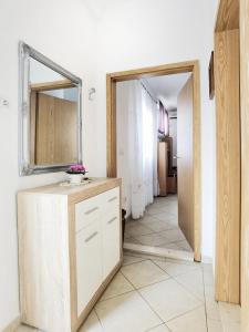 a bathroom with a sink and a mirror on the wall at Apartment Rina - Old Town in Dubrovnik