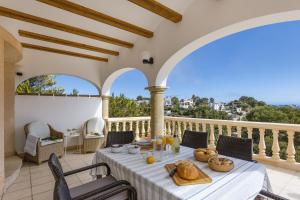 a table with bread and drinks on a balcony at Casa Thalassa in Balcon del Mar