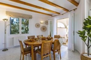 a dining room with a wooden table and chairs at Casa Thalassa in Balcon del Mar