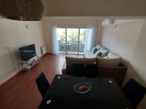 a living room with a couch and a table at Casa Capri Salta in Salta