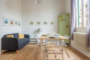een woonkamer met een tafel en een bank bij Borgo Pinti's Duplex Apartment in Florence