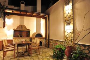 a dining room with a table and a pizza oven at Pansion Evi in Ammouliani
