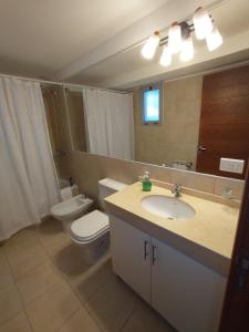 a bathroom with a sink and a toilet and a mirror at Casa Capri Salta in Salta +29 photos