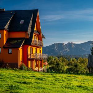 una casa en una colina con montañas en el fondo en Willa Paula, en Ząb