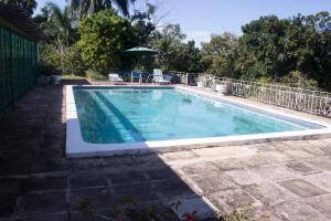 a swimming pool in a yard next to a house at Country Side Cottages in Oracabessa