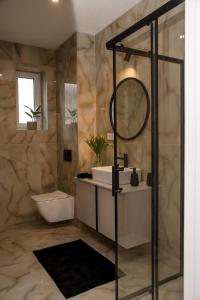 a bathroom with a sink and a mirror at Rezidencia pod Zámkom Bojnice in Bojnice