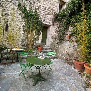 a table and chairs sitting in front of a building at La Fontaine in Bargème