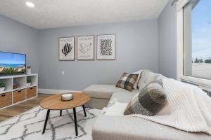 a living room with a couch and a table at Elegant Boho Retreat - 8 min to WEM in Edmonton