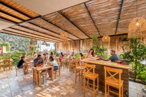 a group of people sitting at tables in a restaurant at Kaş Joy Glamping in Kas