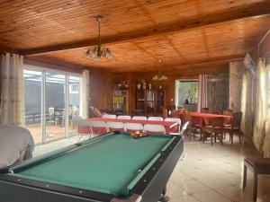 a living room with a pool table and chairs at Entre Volcan et Montagnes in La Plaine des Cafres