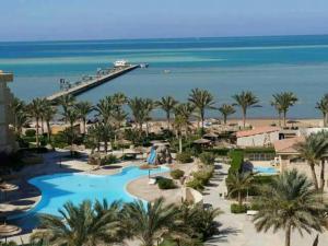 a resort with a swimming pool and a beach at Palma Resort Hurghda in Hurghada