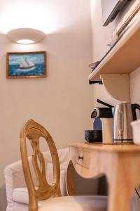 a chair next to a table with a coffee maker at Affittacamere Irene in Monterosso al Mare