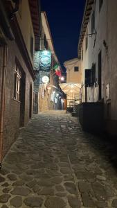 una calle vacía por la noche con un cartel en un edificio en Da Castruccio degli Antelminelli, en Coreglia Antelminelli