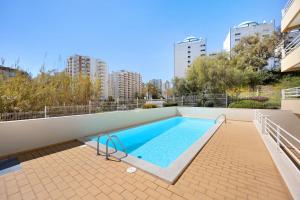 a swimming pool on the roof of a building at Marina In Sight in Portimão