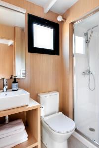 a bathroom with a toilet and a sink and a shower at Wecamp San Sebastián in San Sebastián