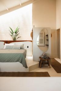 a bedroom with a bed and a mirror at Outro Beach Hotel Cumbuco in Cumbuco