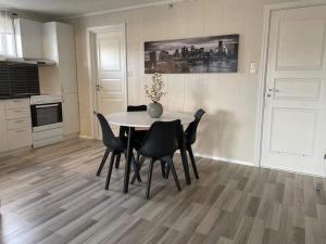 a dining room table and chairs in a kitchen at Sentral og koselig leilighet in Tromsø +7 photos