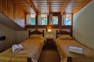 a bedroom with two beds in a house at Bustillo 7500 in San Carlos de Bariloche