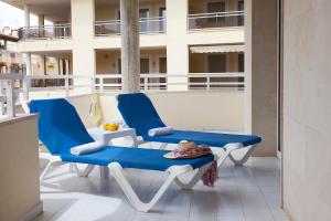 a pair of blue chairs on a balcony at Apartamento Es Trenc 2 in Colonia Sant Jordi