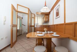 a dining room with a wooden table and chairs at Sunny Beach Apartment by Locap Group in Piran