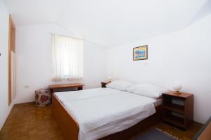 a bedroom with a bed with white sheets and a window at Sunny Beach Apartment by Locap Group in Piran +28 photos