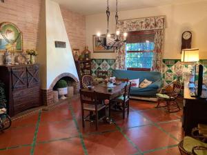 a living room with a table and a fireplace at Huerto Valenciano - Sol y Tranquilidad - Piscina in Valencia
