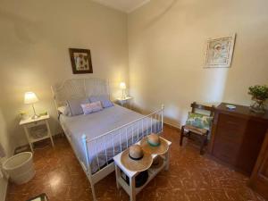 a bedroom with a bed and a table with hats on it at Huerto Valenciano - Sol y Tranquilidad - Piscina in Valencia