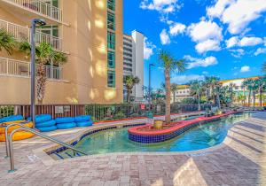 een zwembad in het midden van een gebouw bij Beach Colony Resort Unit 1405 - Beautiful Oceanfront Condo - 1 bedroom, 1 bath - Perfect for 6! in Myrtle Beach