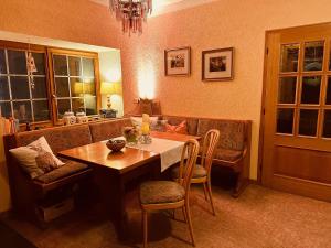 a living room with a table and a couch at Hotel Cafe Restaurant Loreleyblick in Sankt Goar