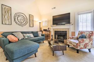 a living room with a couch and a fireplace at Cozy Norwich Villa on Golf Course Near Spa! in Norwich