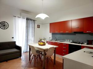 a kitchen with a table with a bowl of fruit on it at Don Mario Aparthotel & Rooms in Marina di Camerota