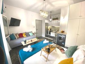a living room with a couch and a table at Artzy petit apartment close to the center in Heraklio Town