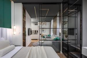 a bedroom with a bed and a living room at Dream Fiumara Apartments in Rijeka